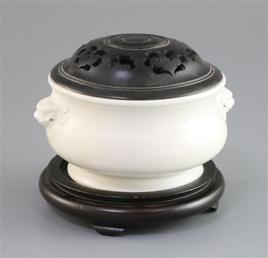 A Chinese Dehua blanc de chine censer, gui, 17th/18th century, W. 14cm, restored, wood cover and stand